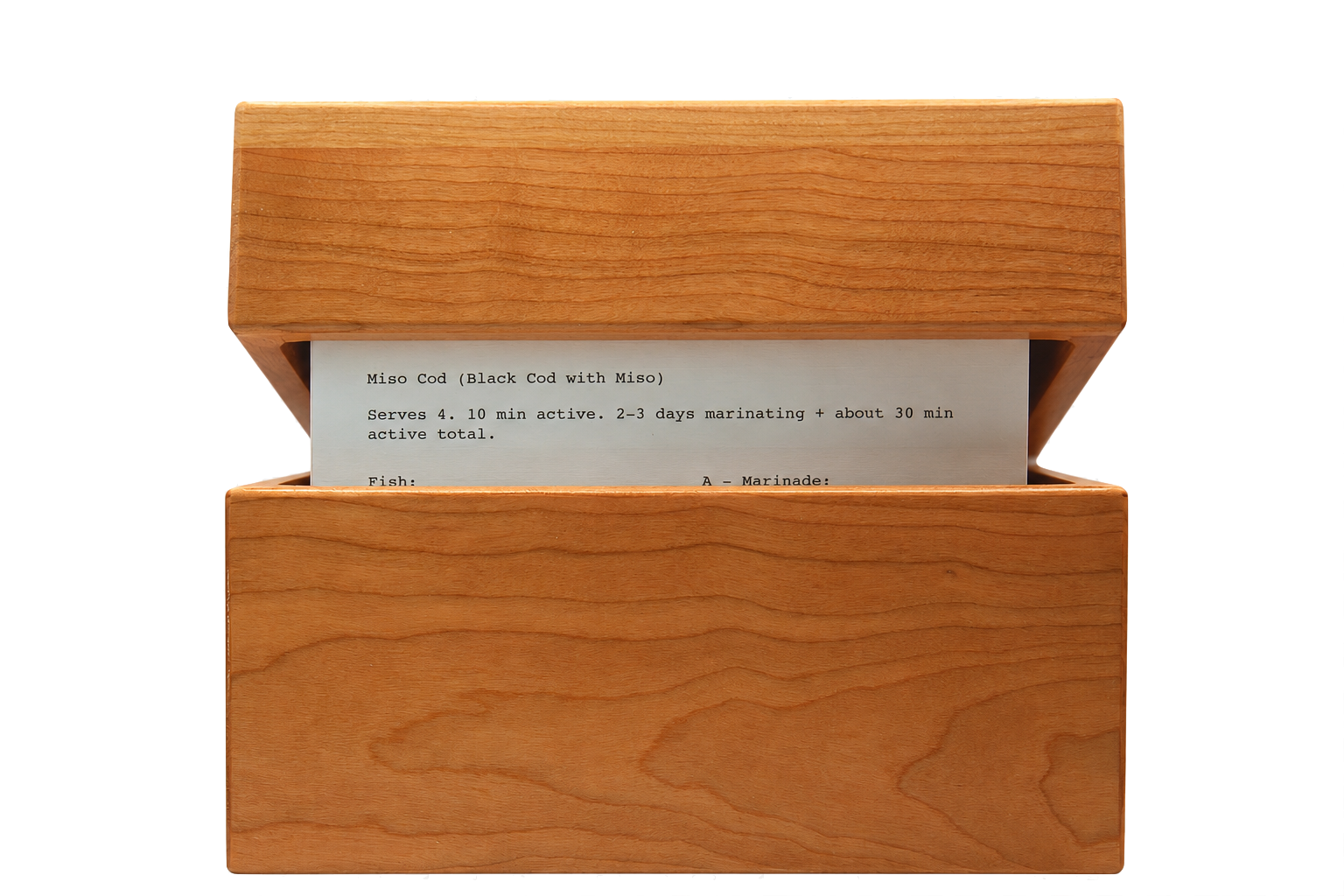 Cracked-open hardwood recipe box showing cards inside